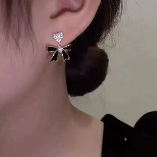 Black bow crystal heart earrings by Aurex