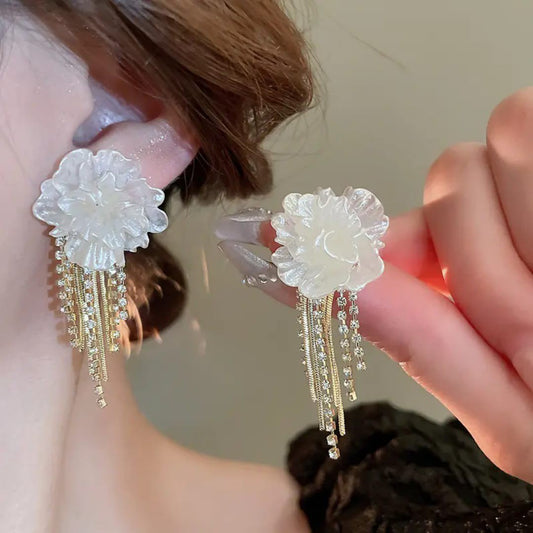White flower gold-tone fringe earrings by Aurex