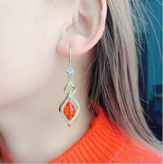 Red stone open-frame hook earrings by Aurex