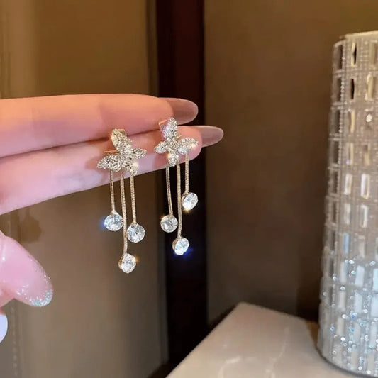 Crystal butterfly tassel earrings by Aurex